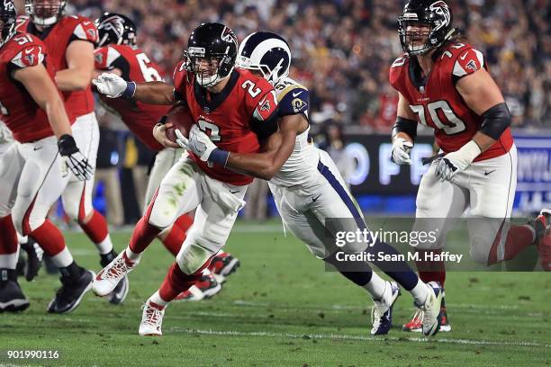 Robert Quinn of the Los Angeles Rams sacks Matt Ryan of the Atlanta Falcons during the NFC Wild Card Playoff Game at the Los Angeles Coliseum on...