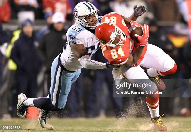 Kansas City Chiefs tight end Demetrius Harris catches a pass in front of the Tennessee Titans' Jayon Brown in the fourth quarter on Saturday, Jan. 6...