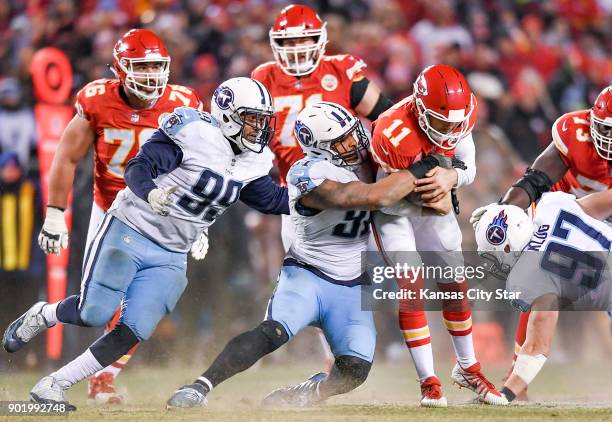 The Tennessee Titans' Jurrell Casey , Derrick Morgan and Karl Klug conspire to bring down Kansas City Chiefs quarterback Alex Smith as he tried to...
