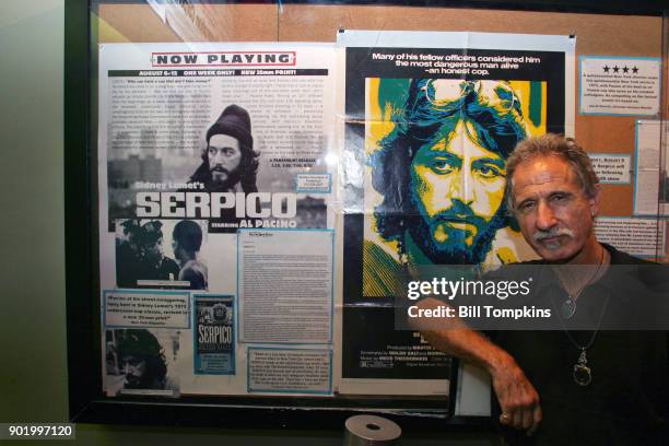 Frank Serpico, former New York City Police Officer, poses in front of the movie poster SERPICO starring Al Pacino at the Quad Cinema movie theatre on...