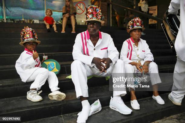 Revelers sit on church steps after performing during Three Kings Day celebrations on January 6, 2018 in Rio de Janeiro, Brazil. Three Kings Day...