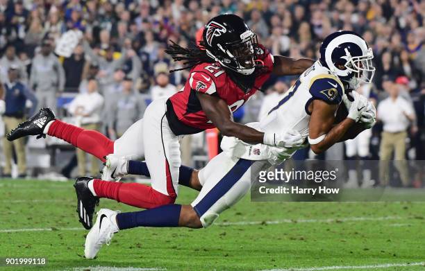 Wide receiver Robert Woods of the Los Angeles Rams makes a catch in front of cornerback Desmond Trufant of the Atlanta Falcons during the second...