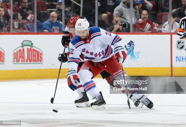 Kevin Shatenkirk of the New York Rangers skates with the puck ahead of Max Domi of the Arizona Coyotes during the third period at Gila River Arena on...
