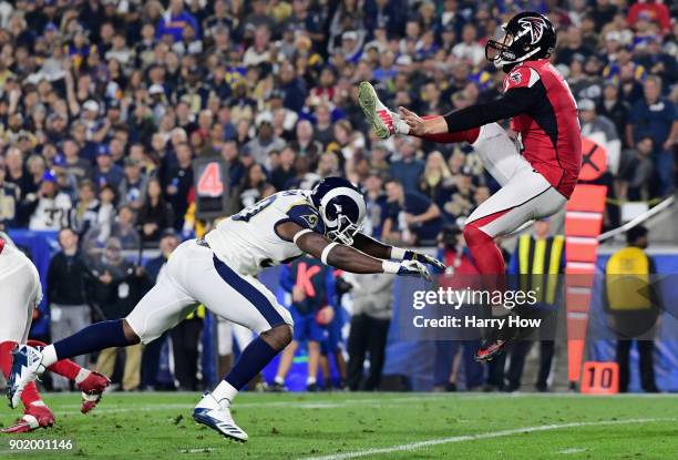 Linebacker Samson Ebukam of the Los Angeles Rams charges punter Matt Bosher of the Atlanta Falcons of the Atlanta Falcons during the second quarter...