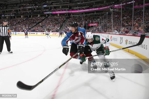 Erik Johnson of the Colorado Avalanche battles for position against Matt Cullen of the Minnesota Wild at the Pepsi Center on January 6, 2018 in...