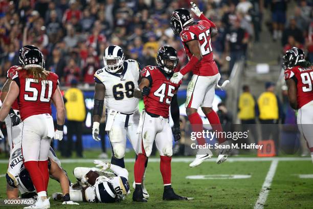 Keanu Neal of the Atlanta Falcons and Deion Jones reacts after tackling Todd Gurley of the Los Angeles Rams during the NFC Wild Card Playoff Game at...