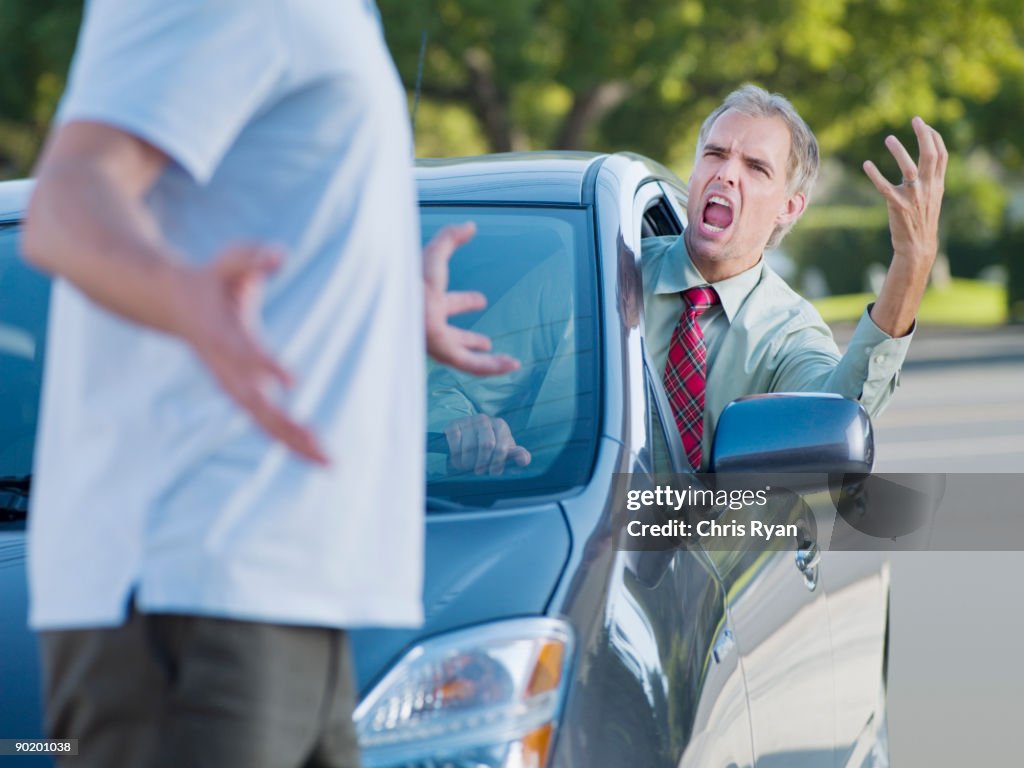 Angry driver shouting at pedestrian blocking road