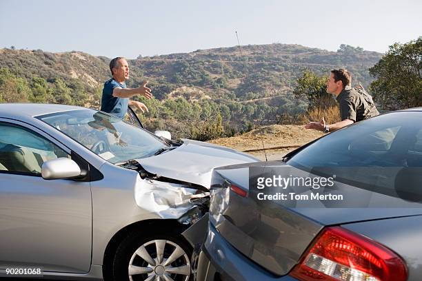 due uomini discutere su auto danneggiata - diverbio foto e immagini stock