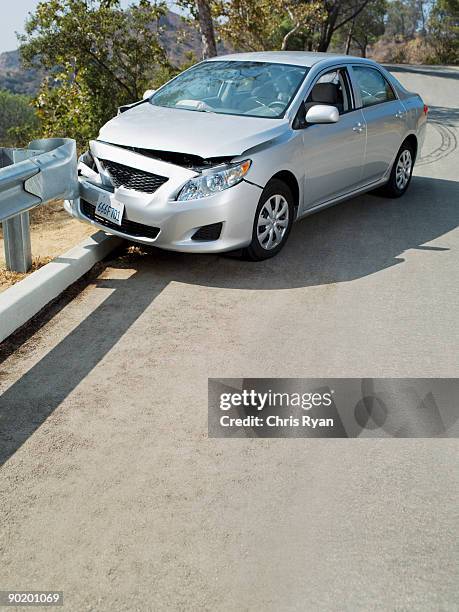 car wrecked on road guardrail - verkeersongeluk stockfoto's en -beelden