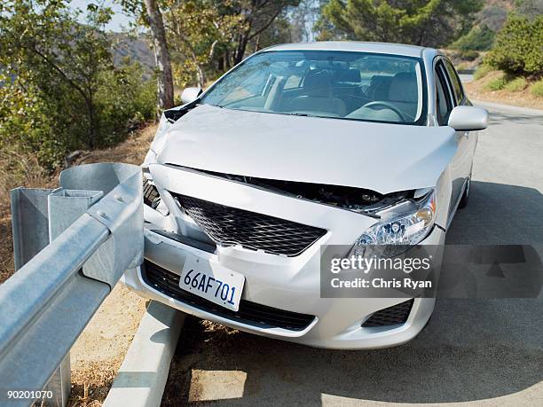 car wrecked on road guardrail - railing stock pictures, royalty-free photos & images