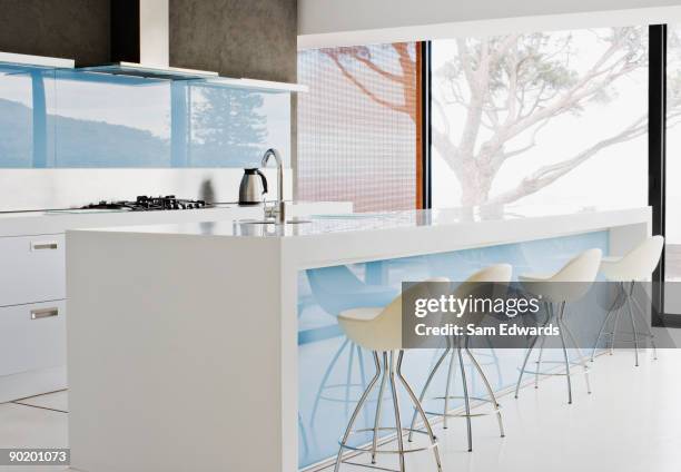 counter island and stools in modern kitchen - bar stool stock pictures, royalty-free photos & images