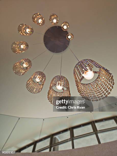 ornate, modern chandelier in a modern home - chandelier stock pictures, royalty-free photos & images
