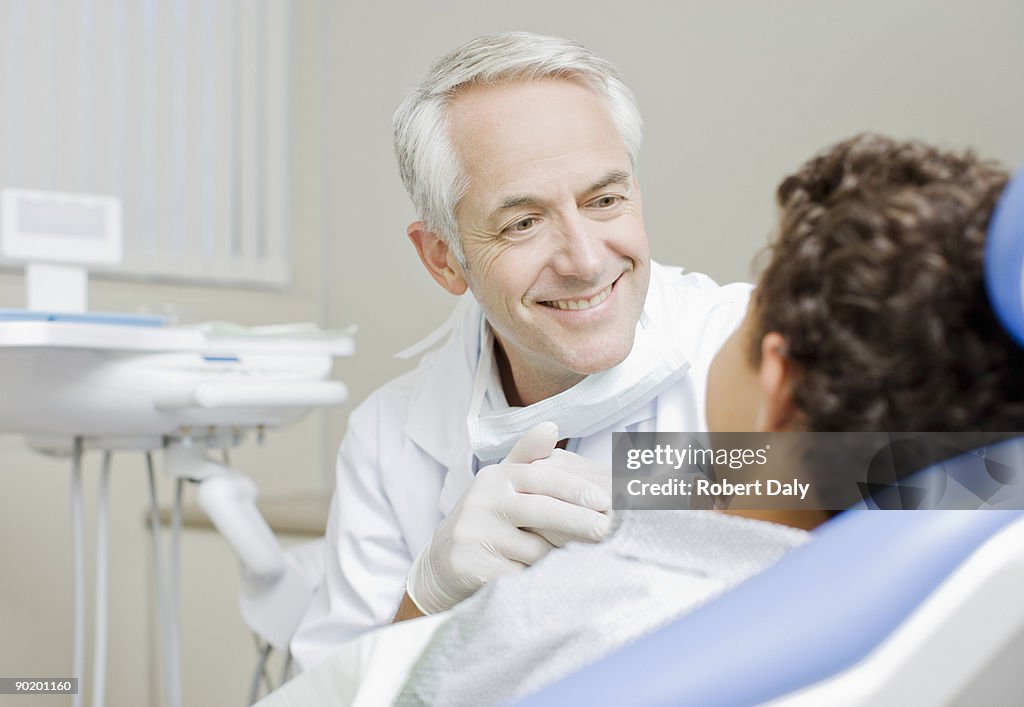 Dentist examining boys teeth
