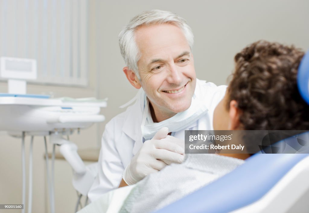 Dentist examining boys teeth