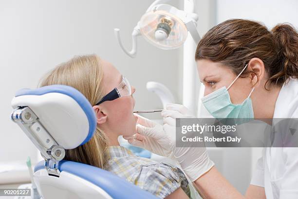 dental hygienist working on patients teeth - dentist office stockfoto's en -beelden