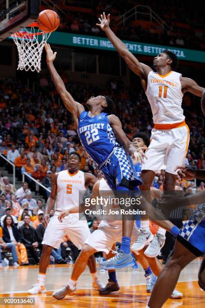 Shai Gilgeous-Alexander of the Kentucky Wildcats drives to the basket against Kyle Alexander of the Tennessee Volunteers in the second half of a game...