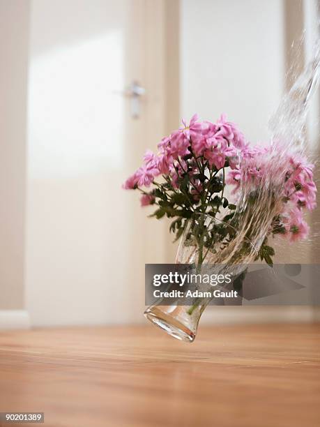 vase of flowers falling on floor - falling stock pictures, royalty-free photos & images