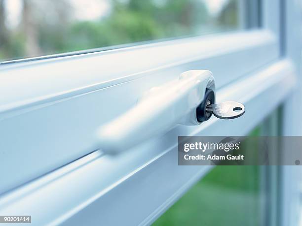 close up of key in window lock - handle stock-fotos und bilder
