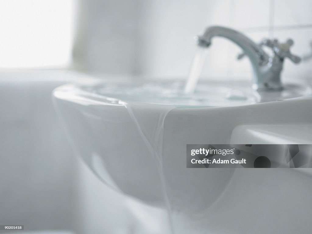 Close up of overflowing bathroom sink