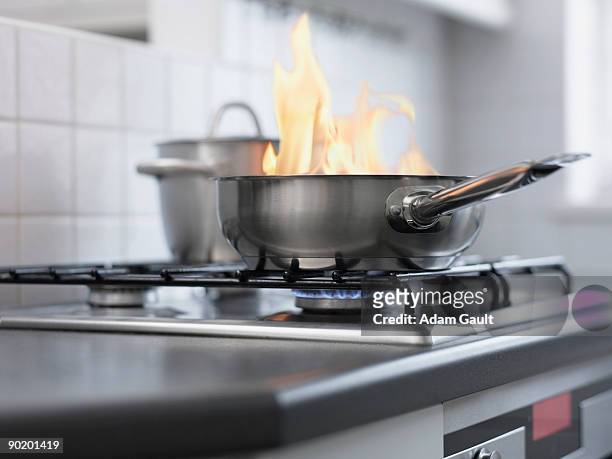food burning in pan on stove - house fire stock-fotos und bilder