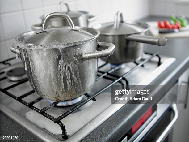 pot boiling over in kitchen - overflowing fotografías e imágenes de stock