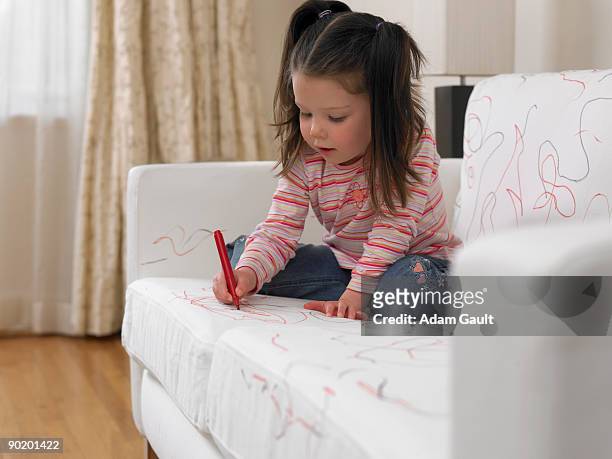 girl using marker on sofa - children misbehaving stock pictures, royalty-free photos & images