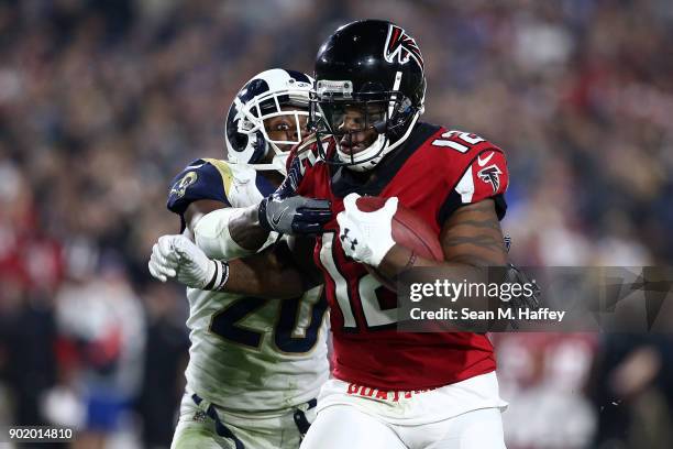 Mohamed Sanu of the Atlanta Falcons runs down field in front of Lamarcus Joyner of the Los Angeles Rams during the NFC Wild Card Playoff Game at the...