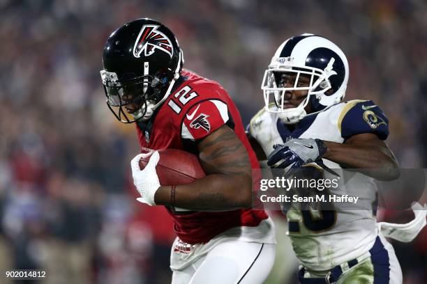 Mohamed Sanu of the Atlanta Falcons runs down field in front of Lamarcus Joyner of the Los Angeles Rams during the NFC Wild Card Playoff Game at the...