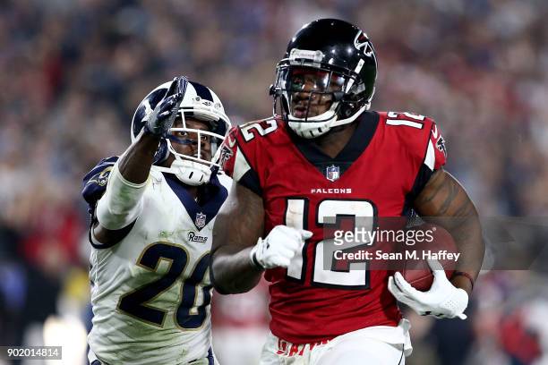 Mohamed Sanu of the Atlanta Falcons runs down field in front of Lamarcus Joyner of the Los Angeles Rams during the NFC Wild Card Playoff Game at the...