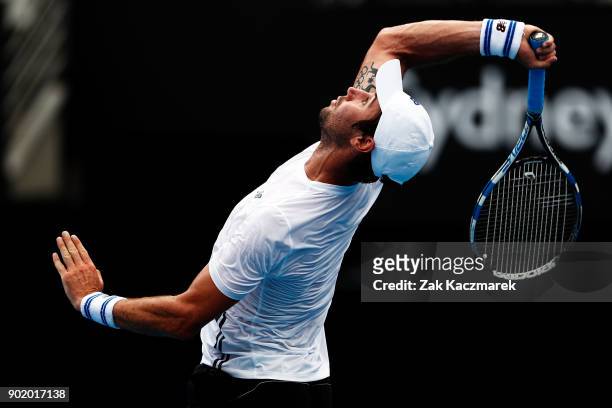 Jordan Thompson of Australia plays an overhead forehand in his first round match against Paolo Lorentzi of Italy during day one of the 2018 Sydney...