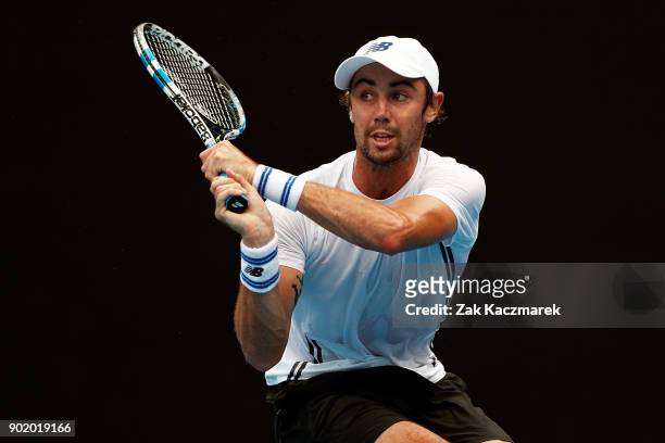 Jordan Thompson of Australia plays a backhand in his first round match against Paolo Lorentzi of Italy during day one of the 2018 Sydney...