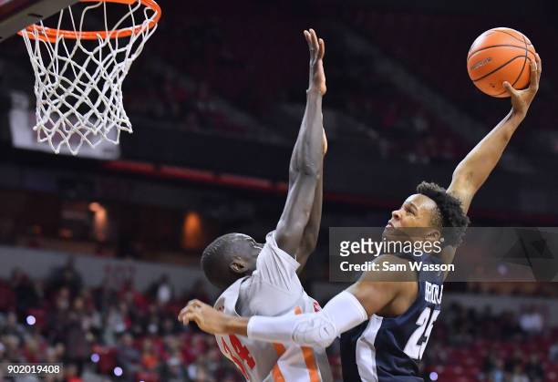 Dwayne Brown Jr. #25 of the Utah State Aggies goes up for a dunk attempt against Cheikh Mbacke Diong of the UNLV Rebels during their game at the...