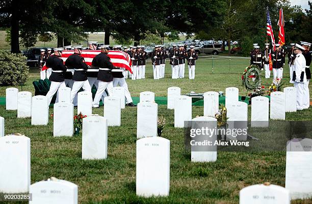Honor guards carry the casket of U.S. Marine Corps Sergeant William Cahir during the funeral of Cahir at Arlington National Cemetery August 31, 2009...