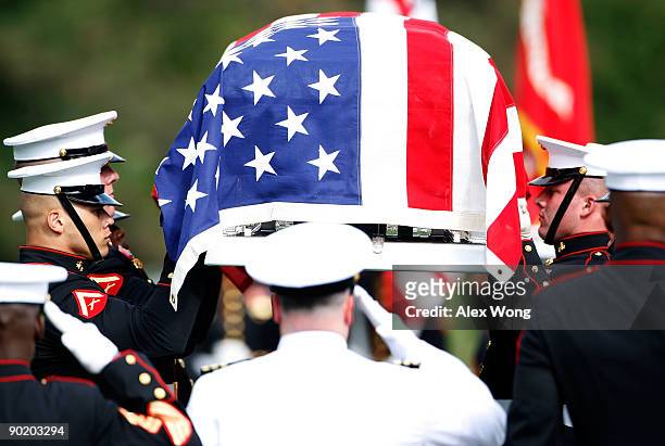 Honor guards life up the casket of U.S. Marine Corps Sergeant William Cahir during the funeral of Cahir at Arlington National Cemetery August 31,...