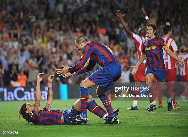 Zlatan Ibrahimovic of Barcelona is congratulated by Gerard Pique and Carles Puyol after he scored his first goal for Barcelona during the La Liga...