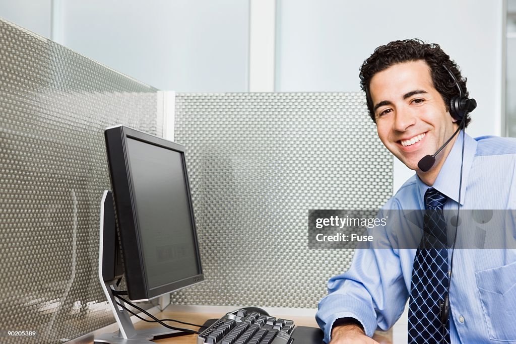 Smiling businessman in cubicle