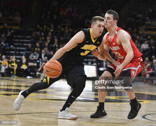 Iowa guard Jordan Bohannon drives past Ohio State guard Andrew Dakich during a Big Ten Conference basketball game between the Ohio State Buckeyes and...