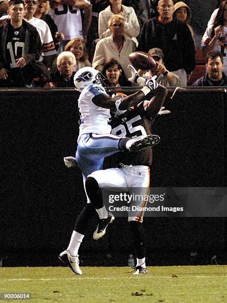 Defensive back Coye Francies of the Cleveland Browns knocks a pass away from wide receiver Paul Williams of the Tennessee Titans during a preseason...