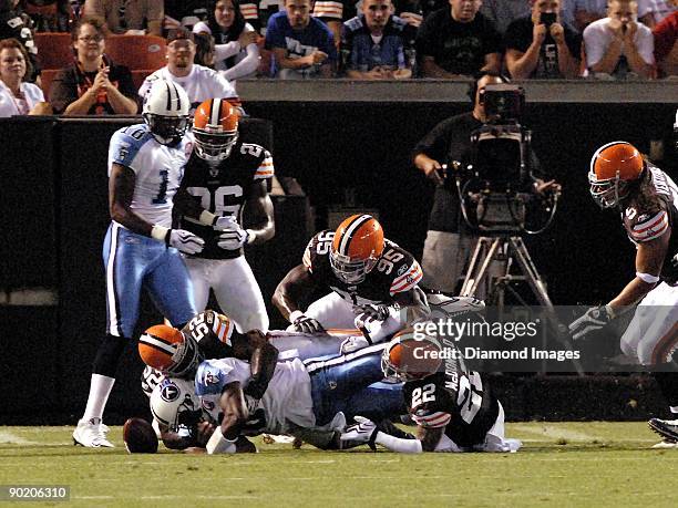 Linebackers D'Qwell Jackson and Kamerion Wimbley and defensive back Brandon McDonald of the Cleveland Browns cause a fumble by quarterback Vince...