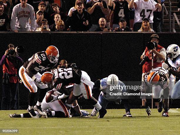 Defensive back Brandon McDonald of the Cleveland Browns recovers a fumble by quarterback Vince Young of the Tennessee Titans during a preseason game...