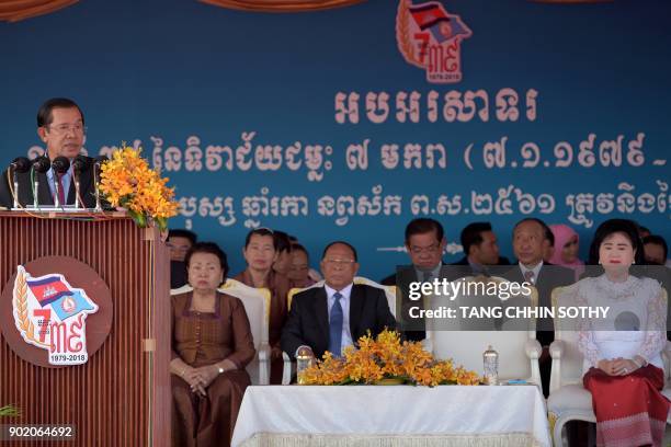 Cambodia's Prime Minister and president of the Cambodian People's Party Hun Sen addresses supporters as his wife Bun Rany , President of the National...