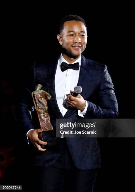 John Legend accepts the Visionary & Spirit of Elysium award onstage at Moet Hennessy John Legend's HEAVEN with the Art of Elysium at Barker Hangar on...