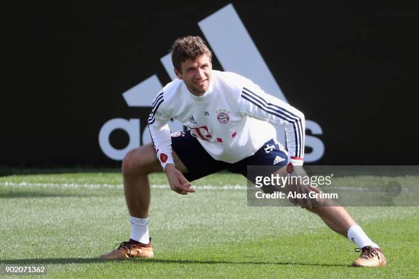 Thomas Mueller stretches during a training session on day 6 of the FC Bayern Muenchen training camp at ASPIRE Academy for Sports Excellence on...