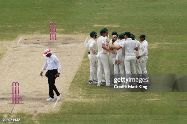 Nathan Lyon of Australia celebrates with team mates after taking the wicket of Alastair Cook of England during day four of the Fifth Test match in...