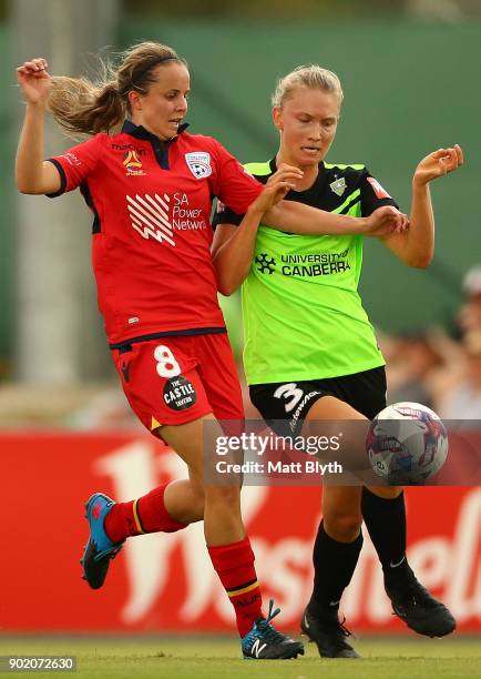 Emily Condon of Adelaide United and Clare Hunt of Canberra United FC compete for the ball during the round 10 W-League match between Canberra United...