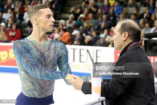 Adam Rippon confers with coach Rafael Arutunian before skating in the Men's Free Skate during the 2018 Prudential U.S. Figure Skating Championships...