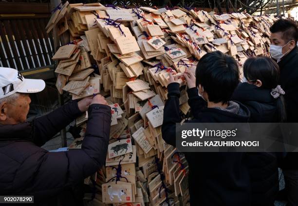 Large number of Ema, wooden votive tablets with wishes on them, are seen at Yushima Tenmangu Shrine in Tokyo on January 7, 2018. Many students and...