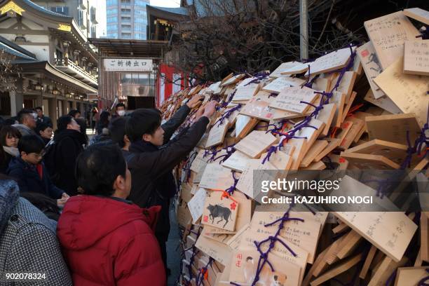 Large number of Ema, wooden votive tablets with wishes on them, are seen at Yushima Tenmangu Shrine in Tokyo on January 7, 2018. Many students and...