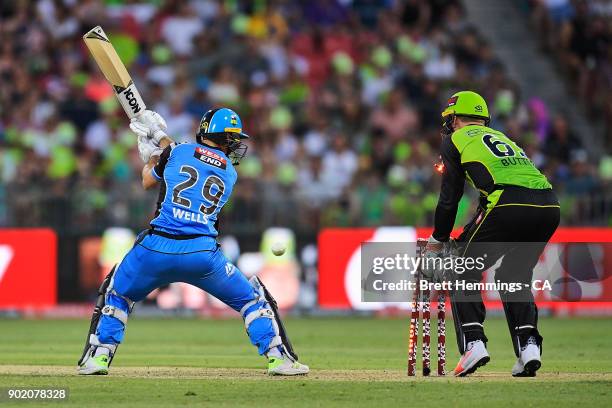 Jonathan Wells of the Strikers is bowled out by Fawad Ahmed of the Thunder during the Big Bash League match between the Sydney Thunder and the...