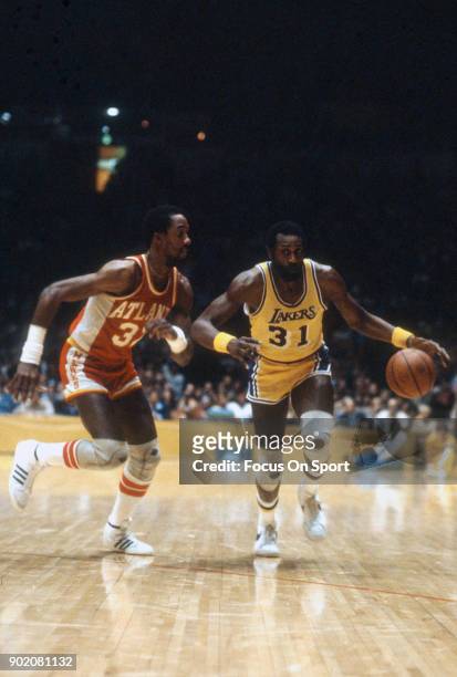 Spencer Haywood of the Los Angeles Lakers dribbles the ball while guarded by Dan Roundfield of the Atlanta Hawks during an NBA basketball game circa...